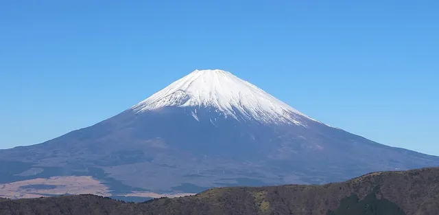 Snow-capped symmetric cone of Mount Fuji viewed from Ōwakudani