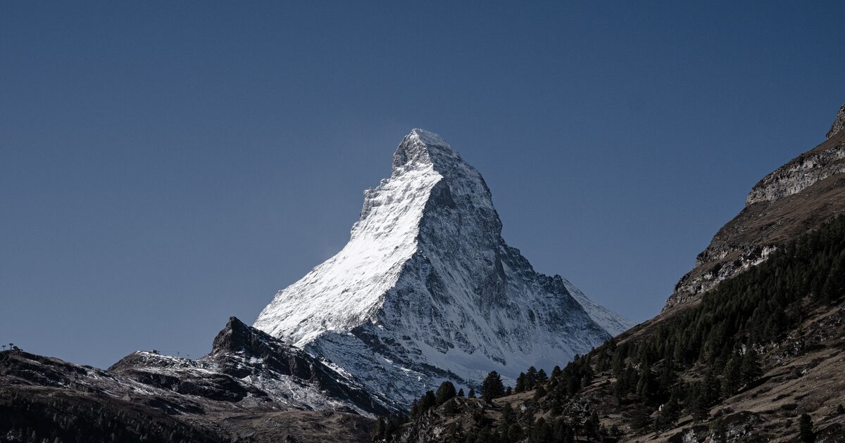 The snow-capped pyramid of the Matterhorn against a clear sky
