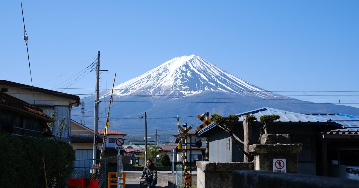 Mount Fuji seen beyond a quiet Japanese town street